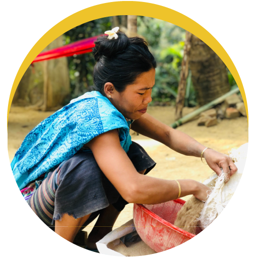 Woman working on her hands and knees, sifting sand